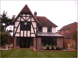 Hand cut vaulted ceiling, roof extension with Tudor cladding and leaded lower area.